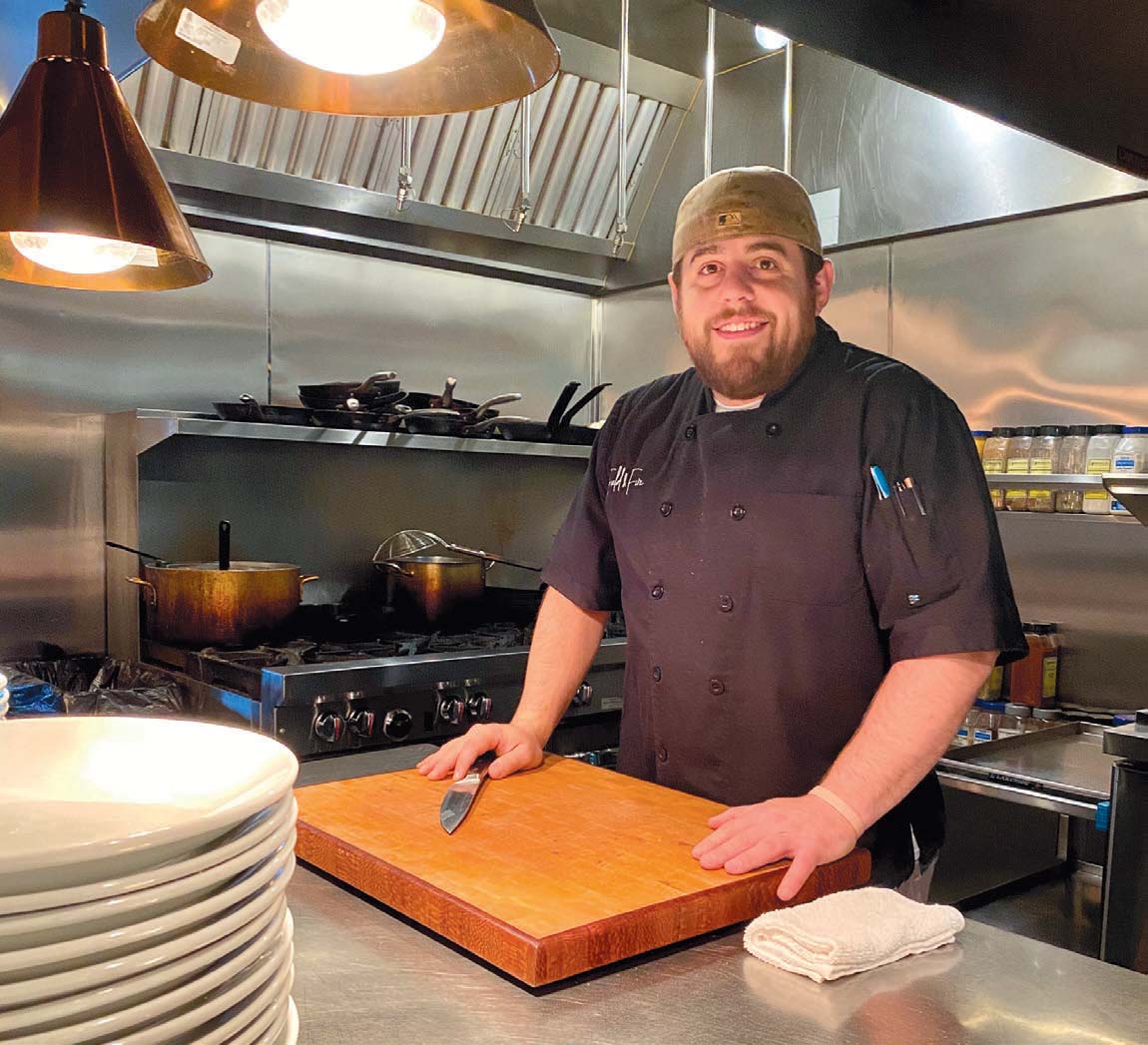 Ryan Sherman in the Field & Fire kitchen. His decision to switch from a career as a research scientist into the culinary arts landed him some national recognition after winning Food Networks’ Cutthroat Kitchen. Photo by Leslie Gast