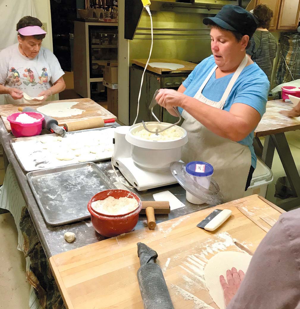 Sigrid Slaby, center, and her busy crew began making lefse once a week in early October increasing to two-times-a-week in the weeks leading up to Christmas. Photo by Leslie Gast